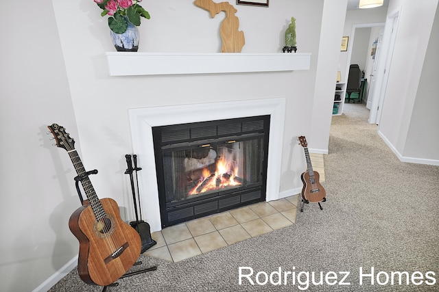 interior details with carpet floors, a glass covered fireplace, and baseboards