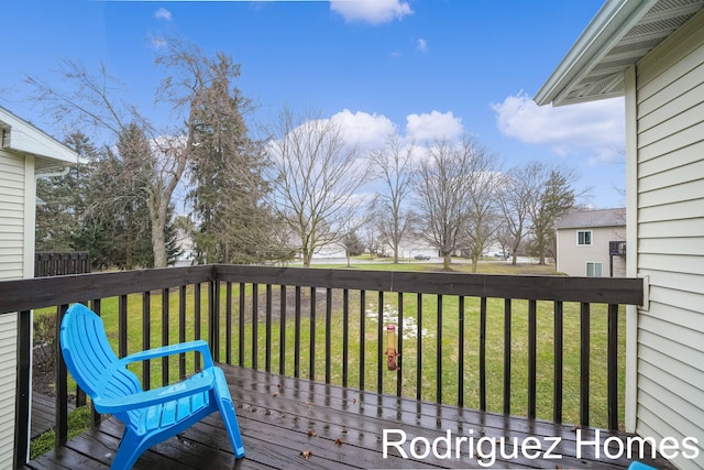 wooden deck featuring a yard