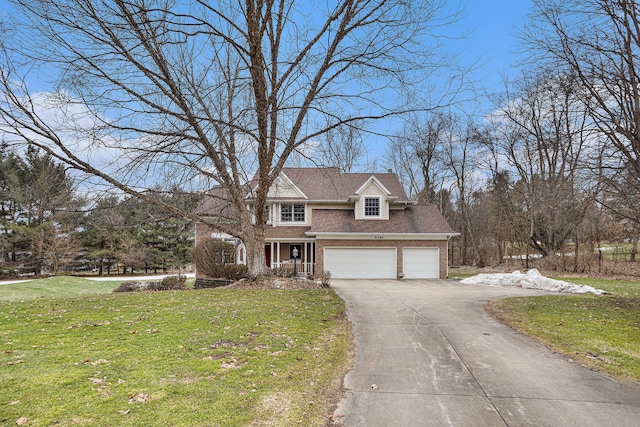 view of front facade featuring driveway, a garage, a front lawn, and brick siding