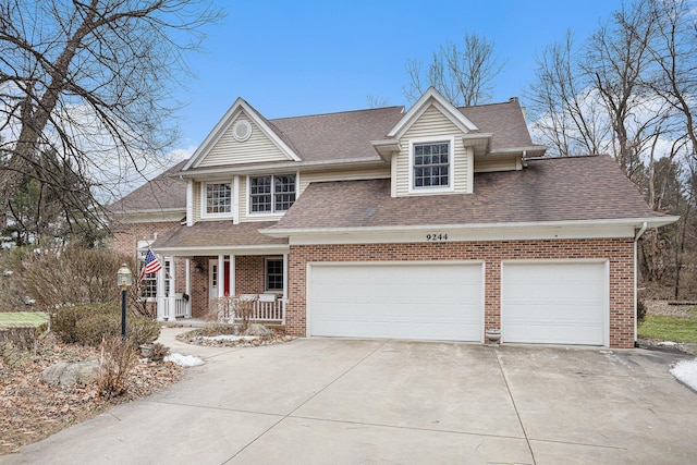 view of front of home with a porch, brick siding, driveway, and an attached garage