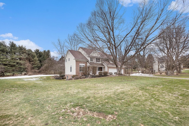 view of front of property with brick siding and a front yard