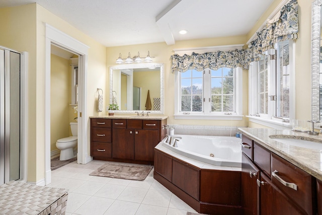 full bathroom with a sink, a jetted tub, toilet, and tile patterned floors