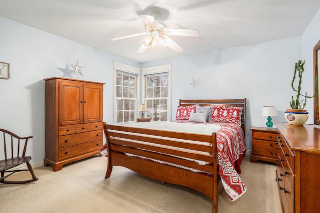 bedroom with a ceiling fan and light colored carpet