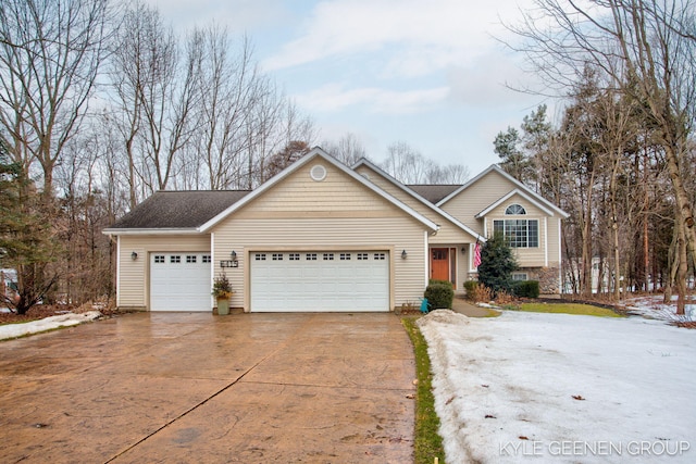 tri-level home with a garage and concrete driveway