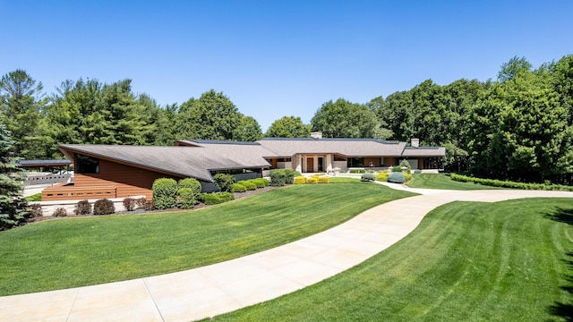 view of front of house with a front yard and concrete driveway