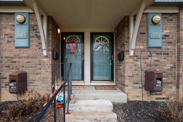 view of exterior entry with brick siding