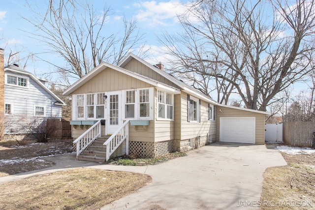 view of front of home featuring a sunroom, entry steps, concrete driveway, and fence