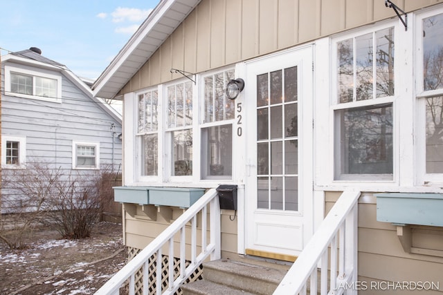 property entrance featuring board and batten siding