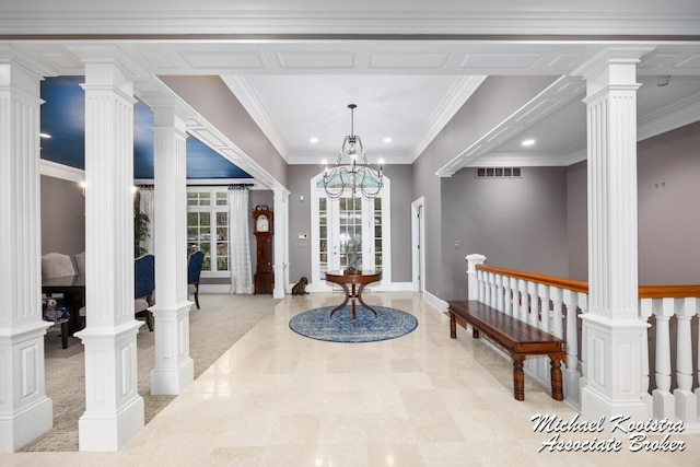 entryway with ornate columns, crown molding, and recessed lighting