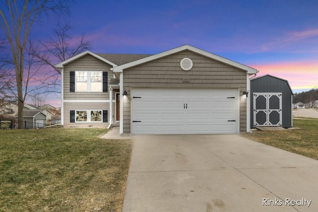 view of front facade with an attached garage, a storage shed, fence, driveway, and a front yard