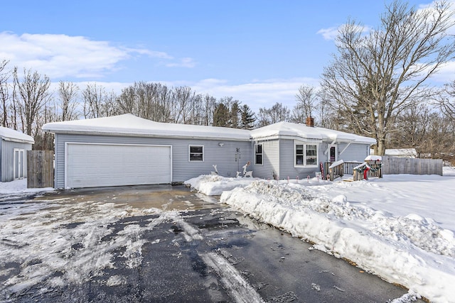 view of front of home featuring an attached garage and fence