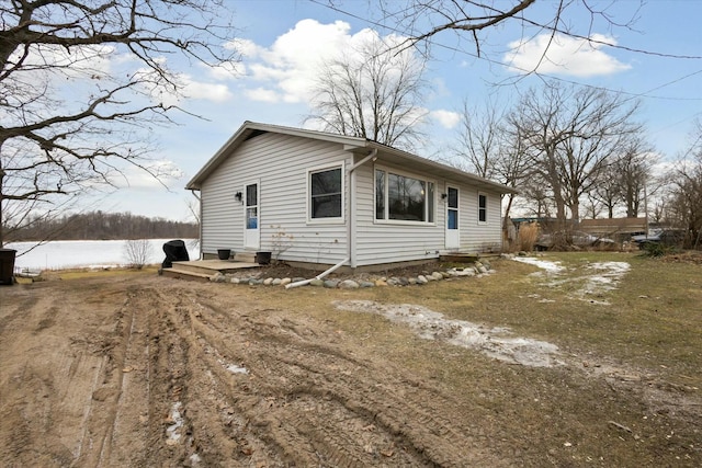 view of property exterior with a water view and cooling unit