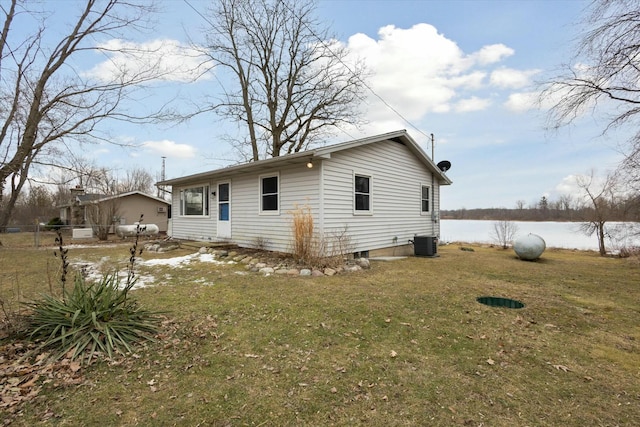 rear view of house with a lawn and central air condition unit