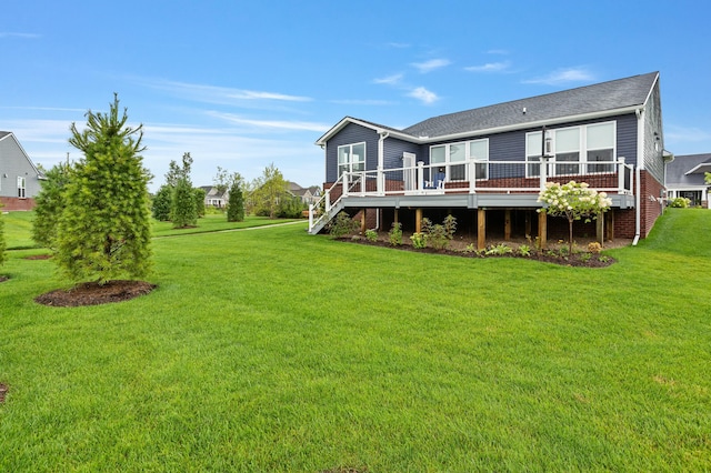 rear view of property with stairway, a lawn, and a wooden deck