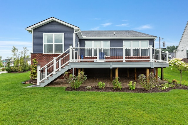 back of house with a wooden deck, stairway, a lawn, and brick siding