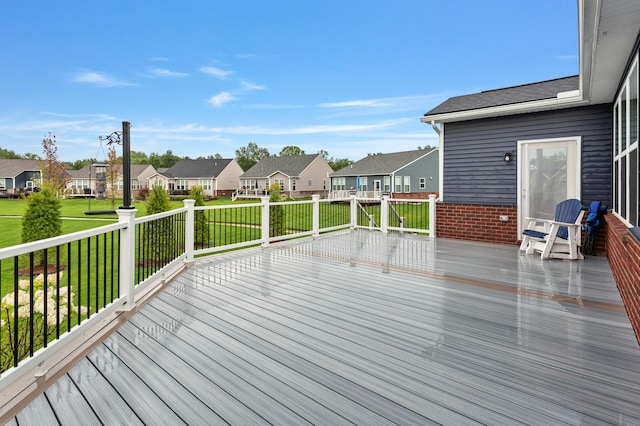 wooden deck with a residential view and a yard