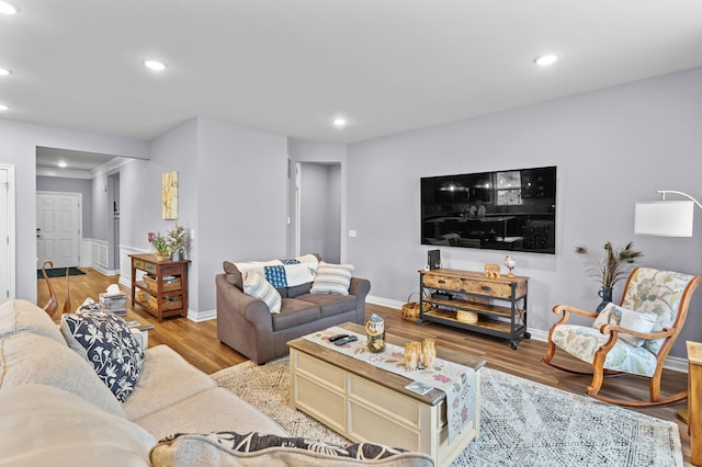 living area featuring recessed lighting, baseboards, and wood finished floors