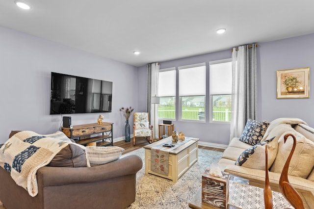 living area featuring recessed lighting, baseboards, and light wood finished floors