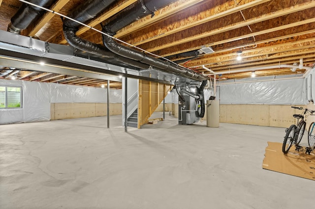 below grade area featuring heating unit, water heater, and stairway