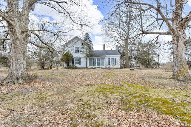 traditional home featuring a chimney