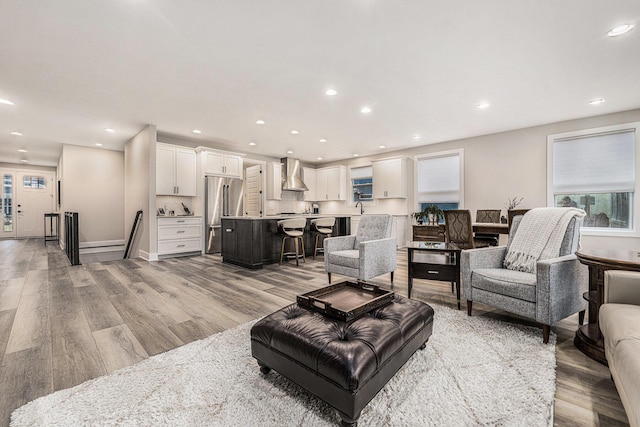 living room featuring light wood-type flooring and recessed lighting