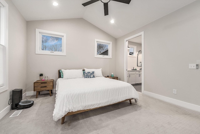 carpeted bedroom with lofted ceiling, recessed lighting, baseboards, and ensuite bathroom