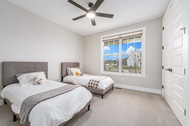 bedroom featuring visible vents, baseboards, ceiling fan, and carpet flooring