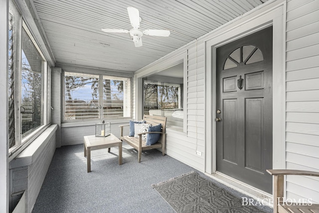 unfurnished sunroom with a ceiling fan