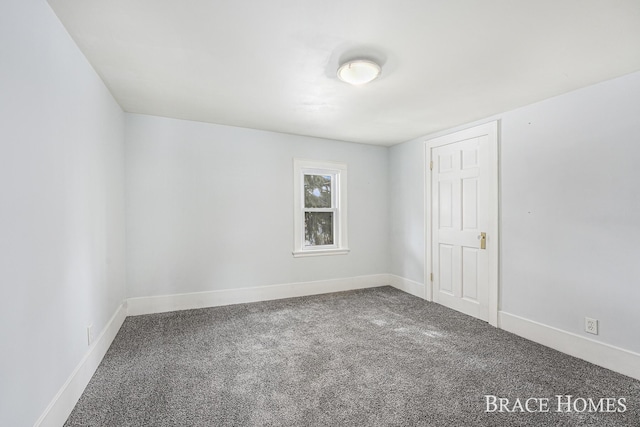 empty room with carpet floors and baseboards