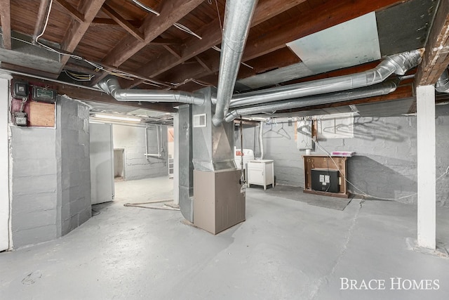 unfinished basement with visible vents and heating unit