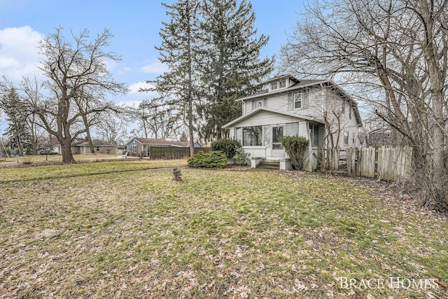 view of front of property with a front yard and fence