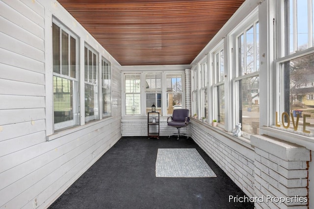 unfurnished sunroom featuring a wealth of natural light and wooden ceiling