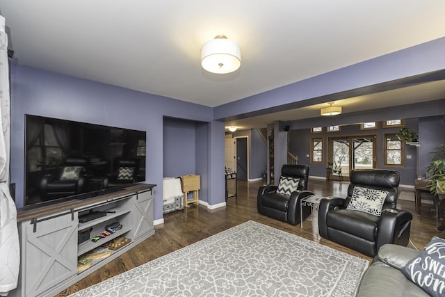 living room featuring dark wood-type flooring and baseboards