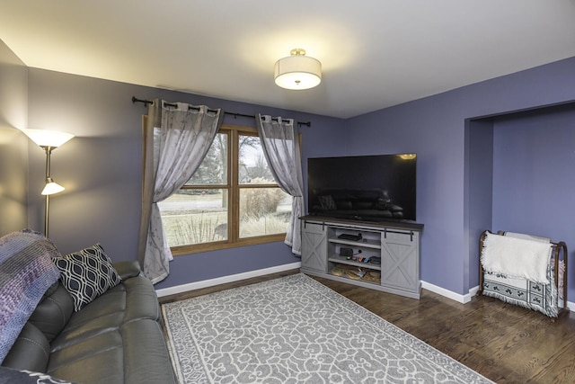 living room featuring baseboards and wood finished floors