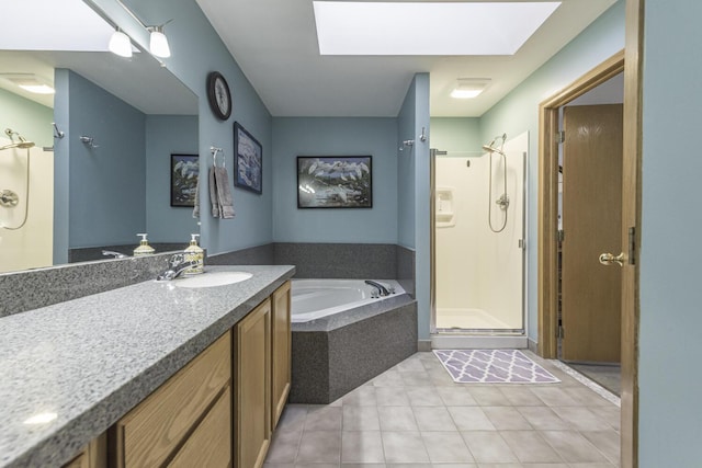 full bath with a skylight, tile patterned flooring, vanity, a shower stall, and a bath