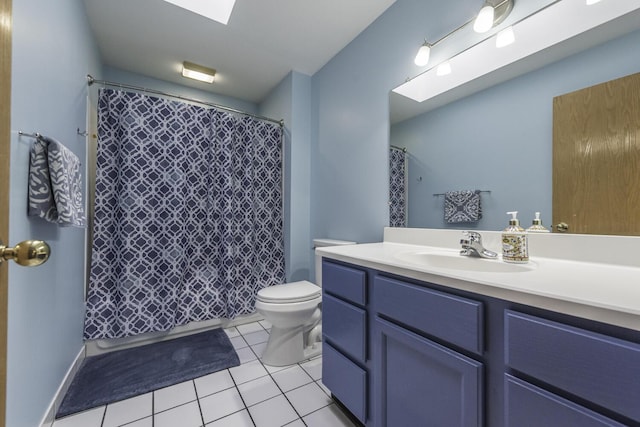 full bath featuring toilet, a skylight, tile patterned flooring, and vanity