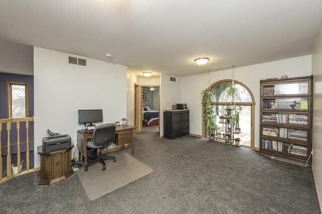 office space featuring carpet floors, visible vents, and baseboards