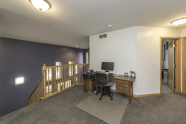 carpeted office featuring visible vents and baseboards