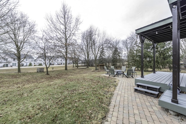 view of yard featuring a fire pit and a wooden deck