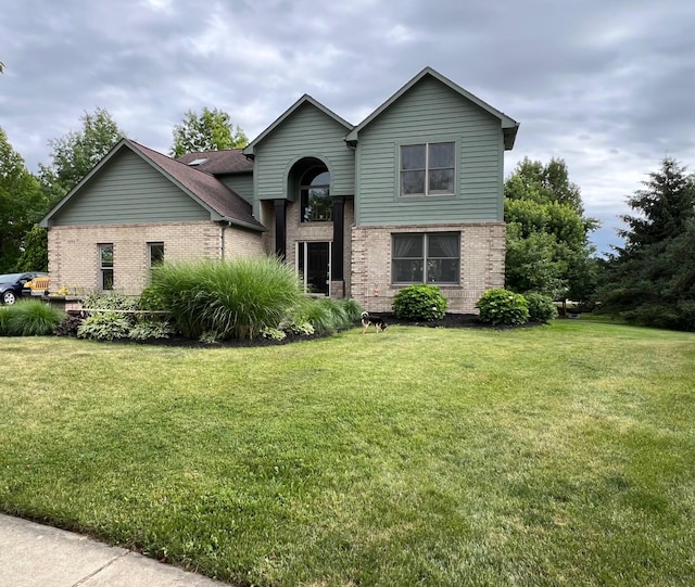 view of front of house with brick siding and a front lawn