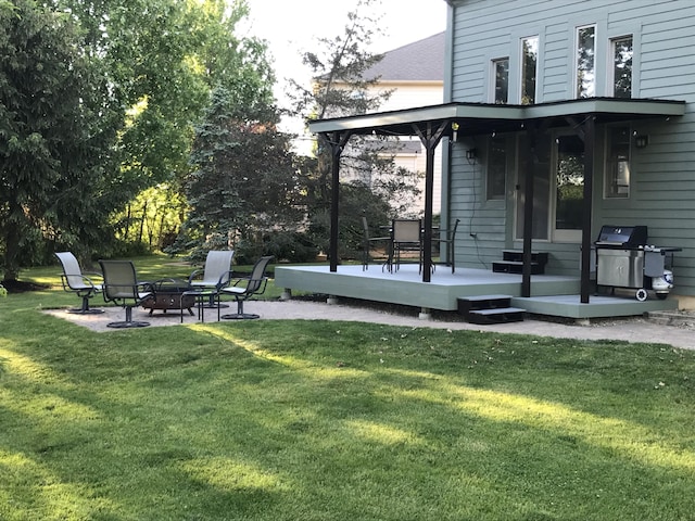 view of yard with a patio area, an outdoor fire pit, and a wooden deck