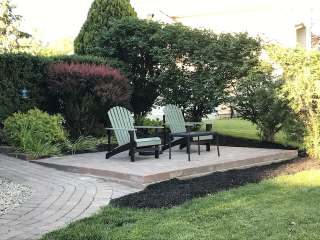 view of community with a lawn and a patio area