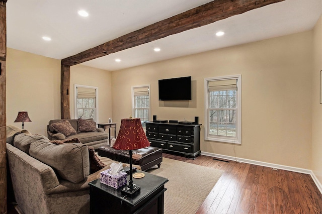 living room with beamed ceiling, plenty of natural light, and baseboards