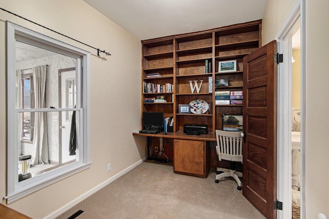 carpeted office featuring baseboards