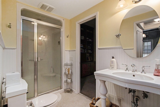 full bath featuring visible vents, a stall shower, and a wainscoted wall