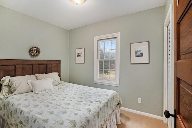 bedroom featuring baseboards and light colored carpet