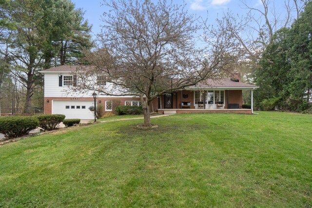 view of front of home with covered porch, a garage, a chimney, and a front yard