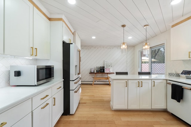 kitchen featuring white fridge with ice dispenser, white cabinets, light countertops, dishwasher, and a peninsula