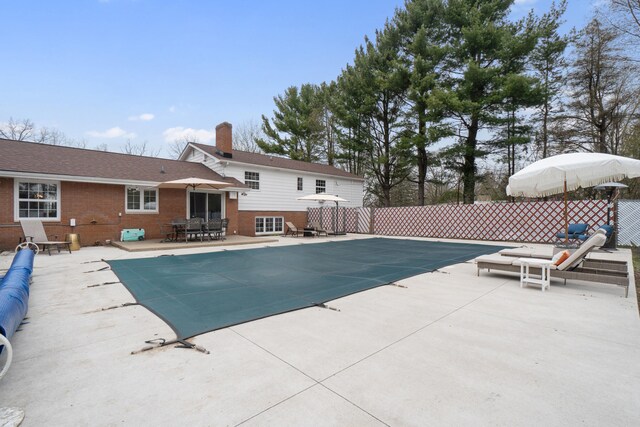 view of pool with a patio, outdoor dining area, a fenced in pool, and fence
