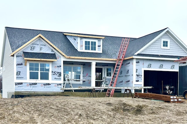 property under construction with roof with shingles and an attached garage